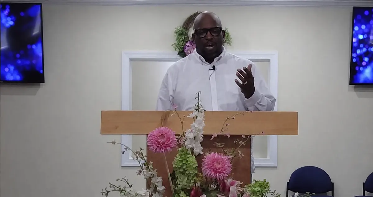 Dexter Graham teaching from a church pulpit